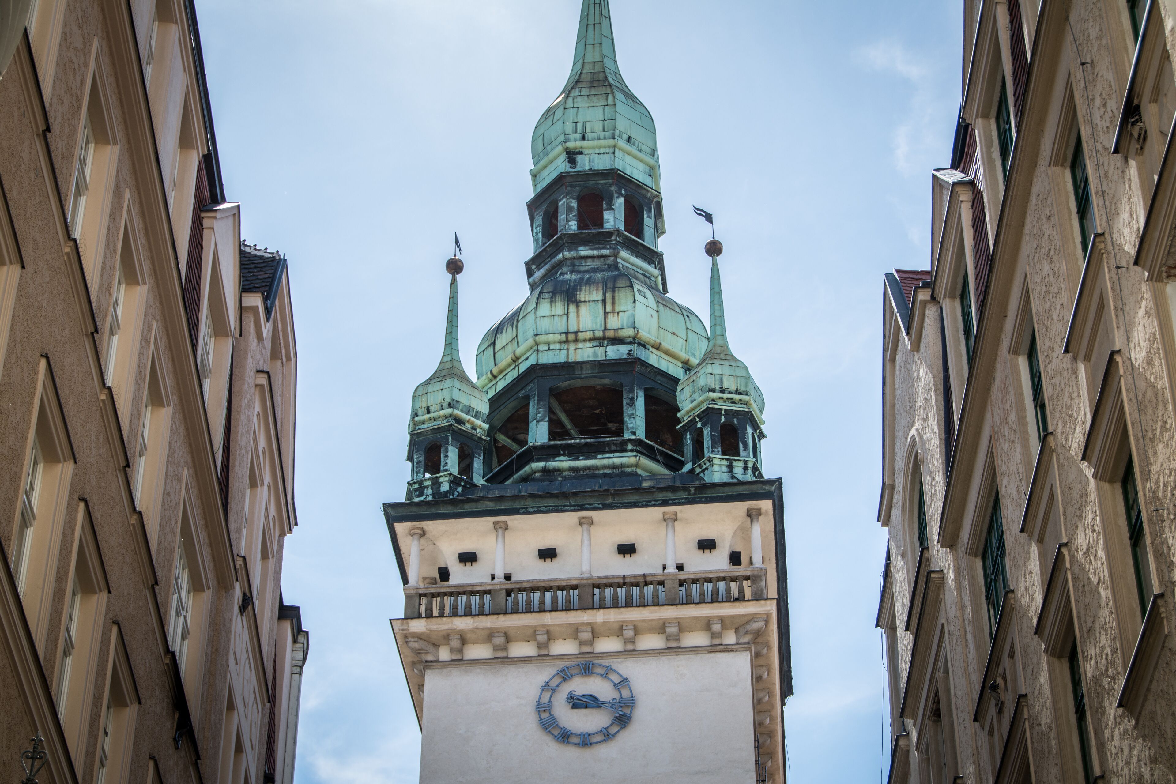 A clock tower with a spire and a clock face.