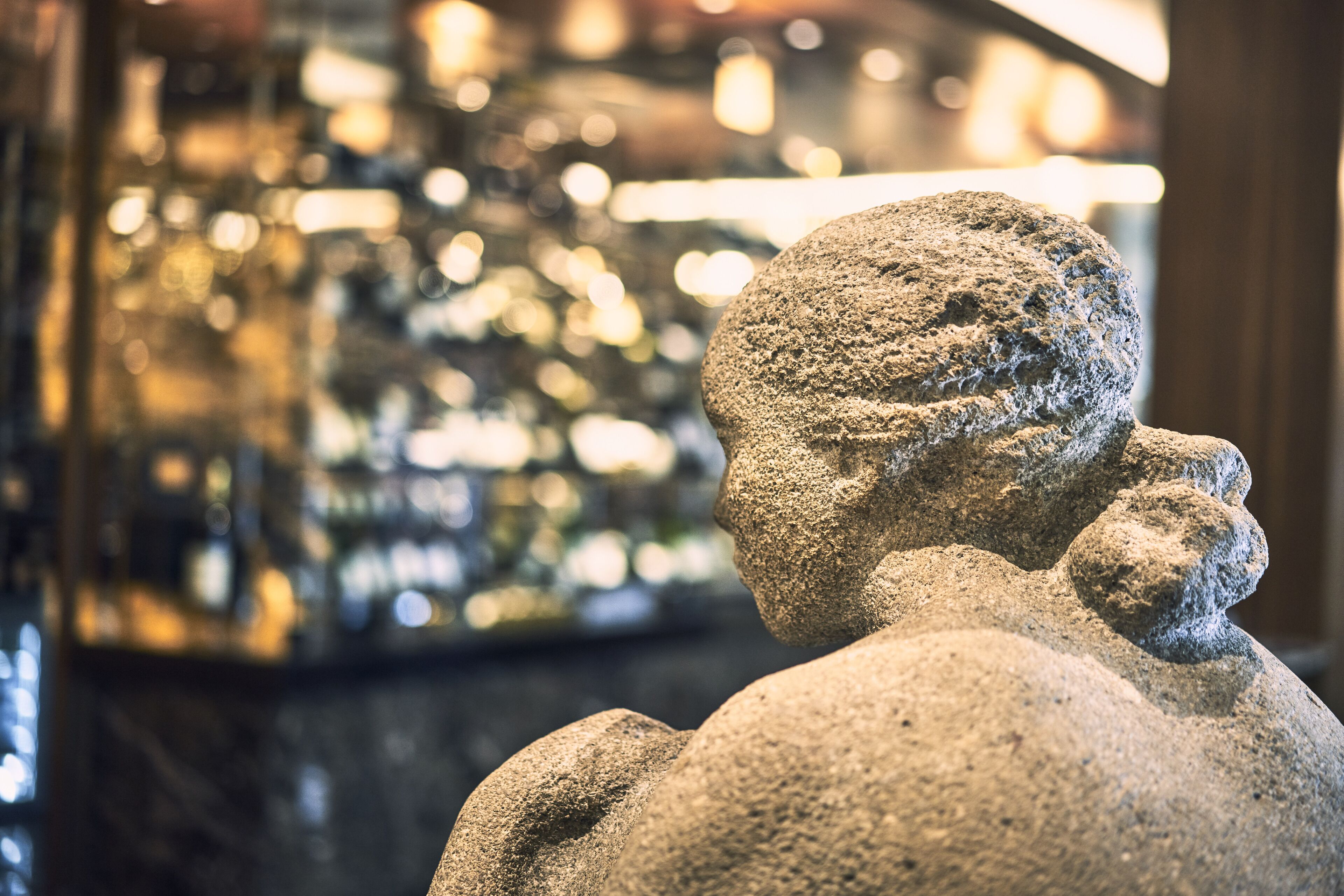 A stone sculpture of a figure holding a child.