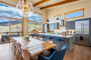 A modern kitchen with a large island, stainless steel appliances, and a view of the mountains. - Modern Mountain Retreat | Resort Amenities | Spacious layout (Silverthorne)