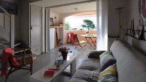 A living room with a sofa, a coffee table, and a dining area with chairs and a table. - Discount (already subtracted) of -40% (Lecci)