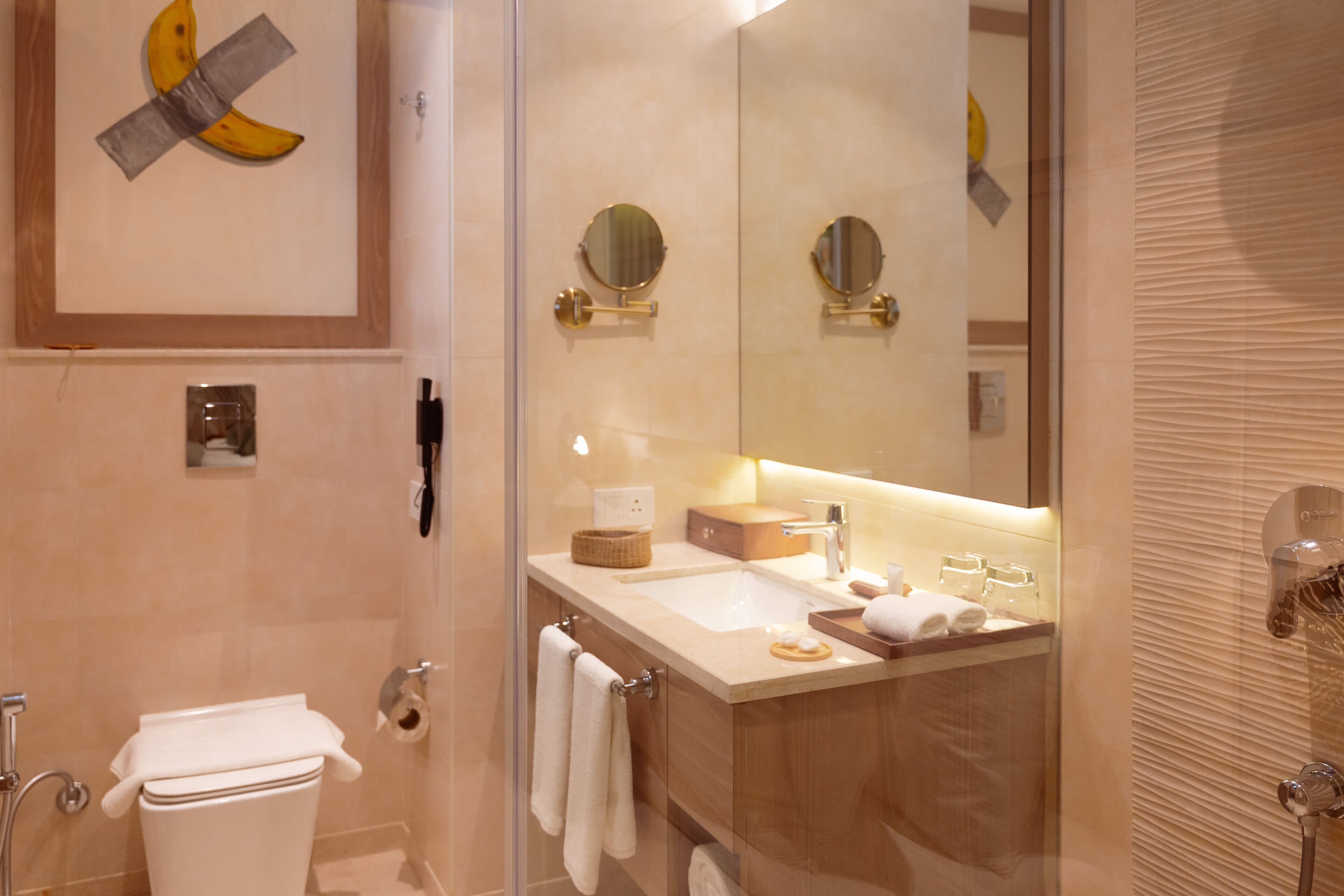 A modern bathroom with a toilet, sink, and shower.