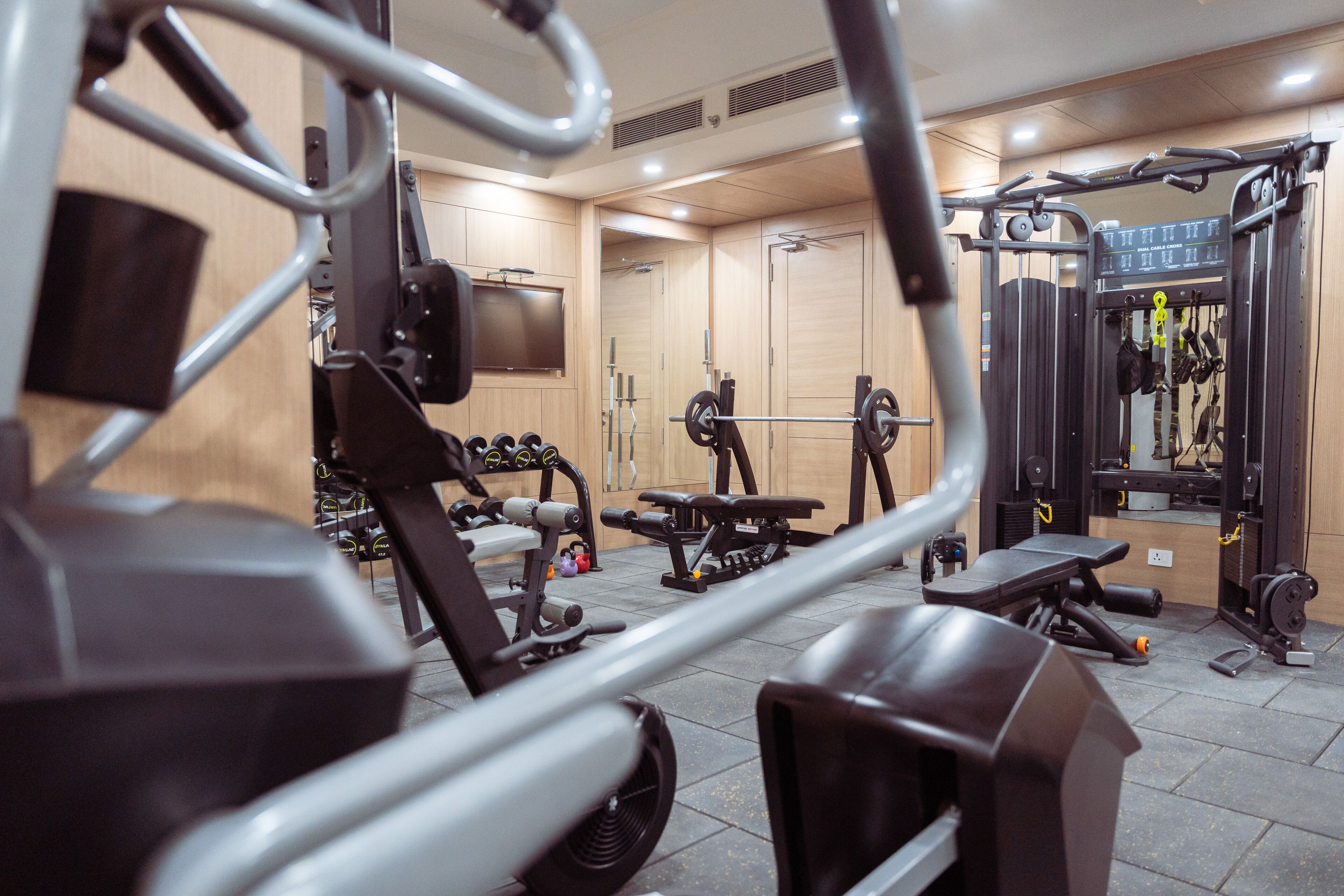 A gym with various exercise equipment, including weight machines and benches.