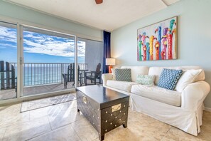 Relax in style with a sofa, coffee table, and balcony overlooking the ocean.