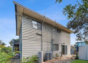 A two-story house with a covered patio, a small front yard, and a garage. - Mindil Arch  Walk to 3 Beaches & River (TOMAKIN)