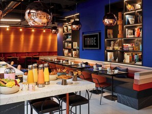 Relax in our lounge area with sofas, chairs, and a communal table offering pastries and beverages.