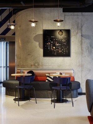 Relax and socialize in this inviting space with a long bench, dining table, and pendant lighting.