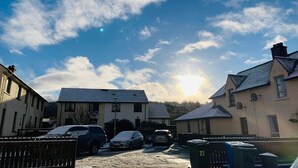 A residential area with houses, parked cars, and a clear sky. - Aonachan Cottage in the village of Spean Bridge (Spean Bridge)