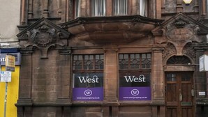 A historic building with ornate architectural details, including a prominent bay window and decorative stonework. - George Street Apartment (Oban)