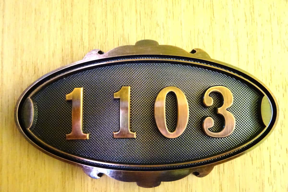 A house number plaque with the number 1103.