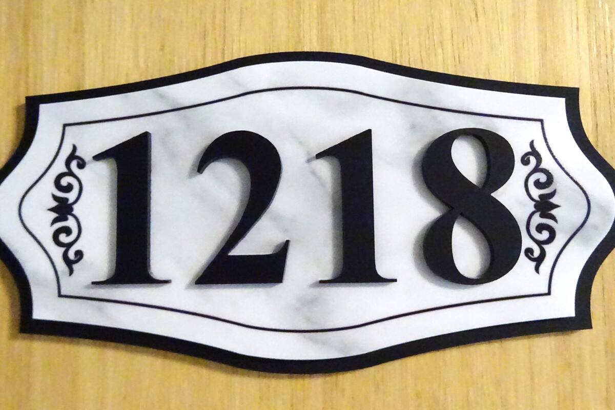 A house number sign with the number 1218.