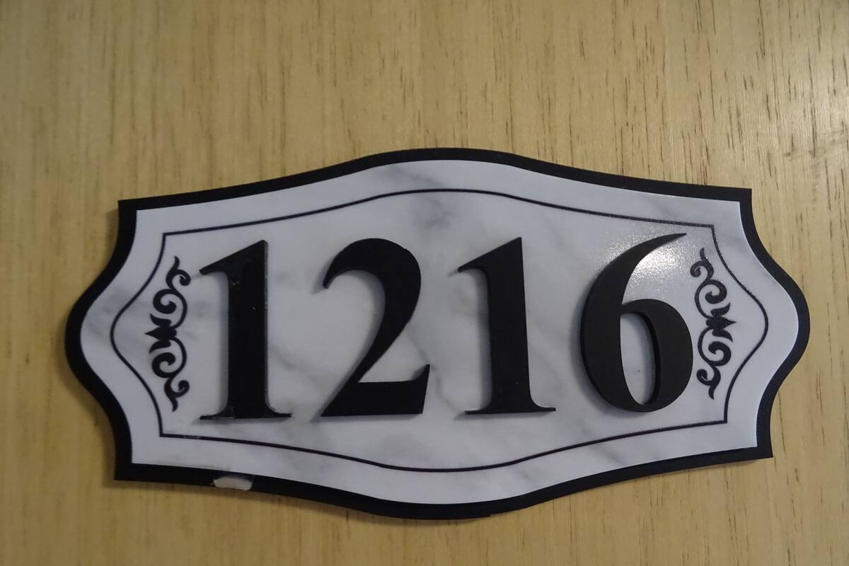 A house number sign with the number 1216.