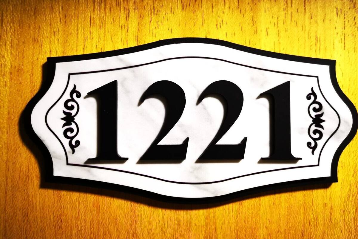 A house number sign with the number 1221.