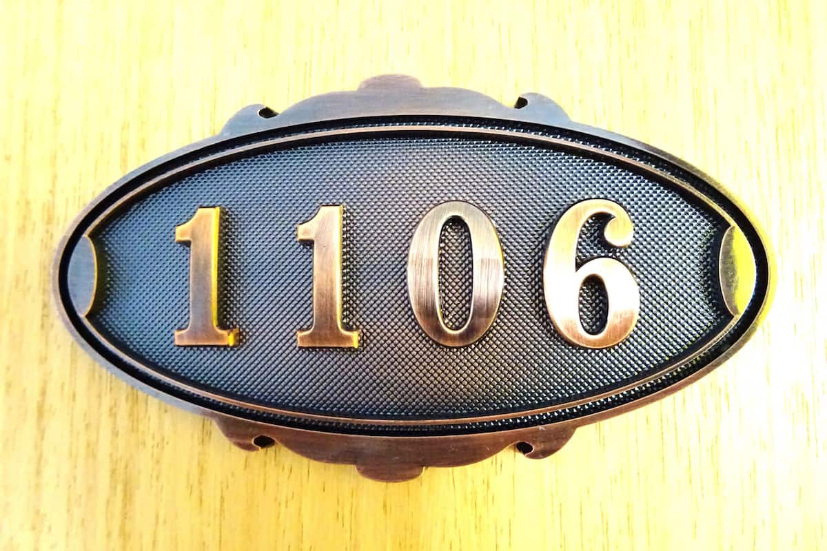 A house number plaque with the digits 1106.