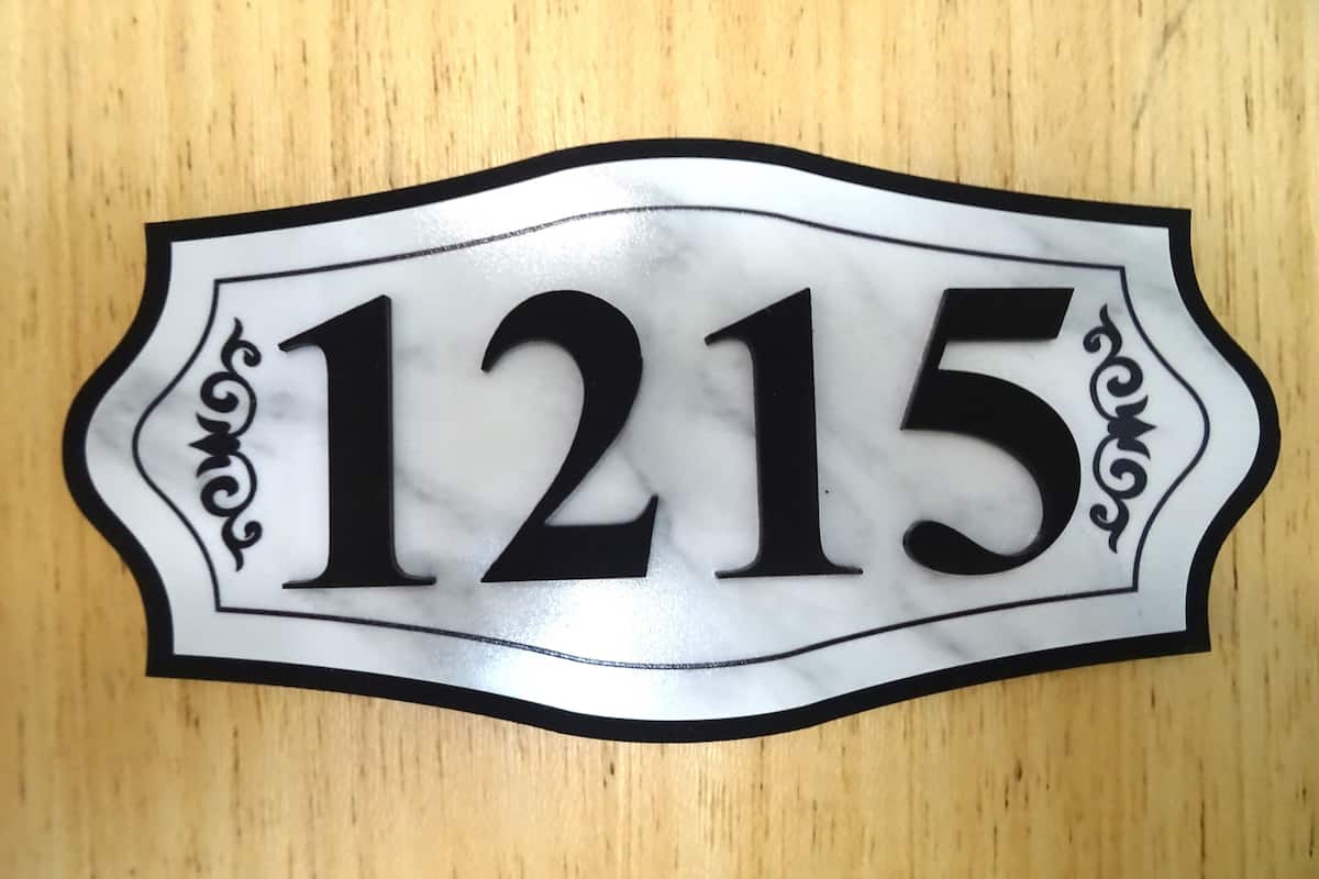 A house number sign with the number 1215.