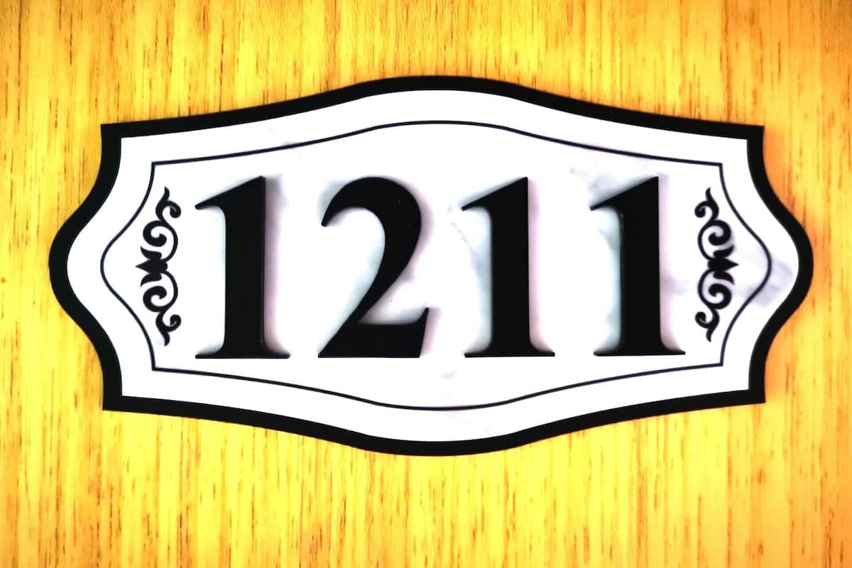 A house number sign with the number 1211.