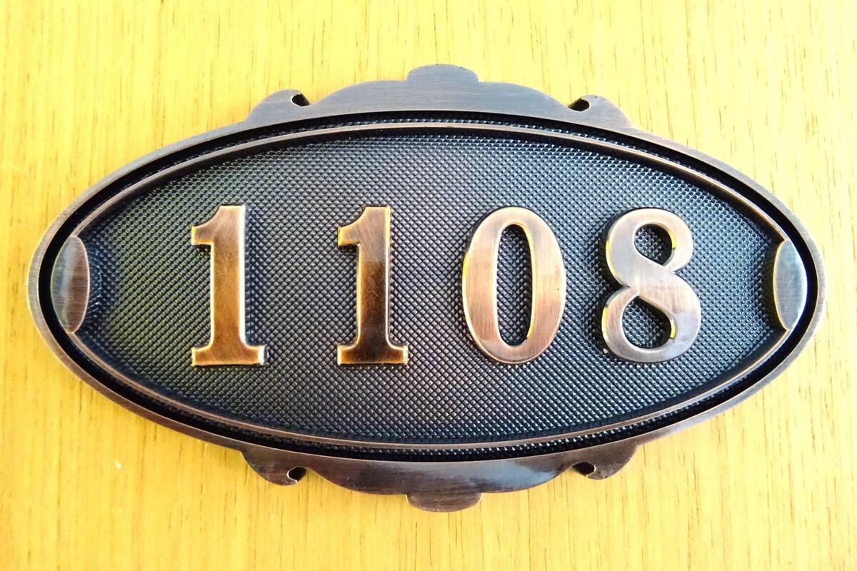 A house number plaque with the digits 1108.