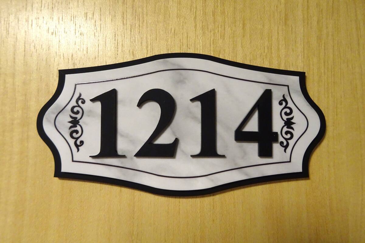 A house number sign with the number 1214.
