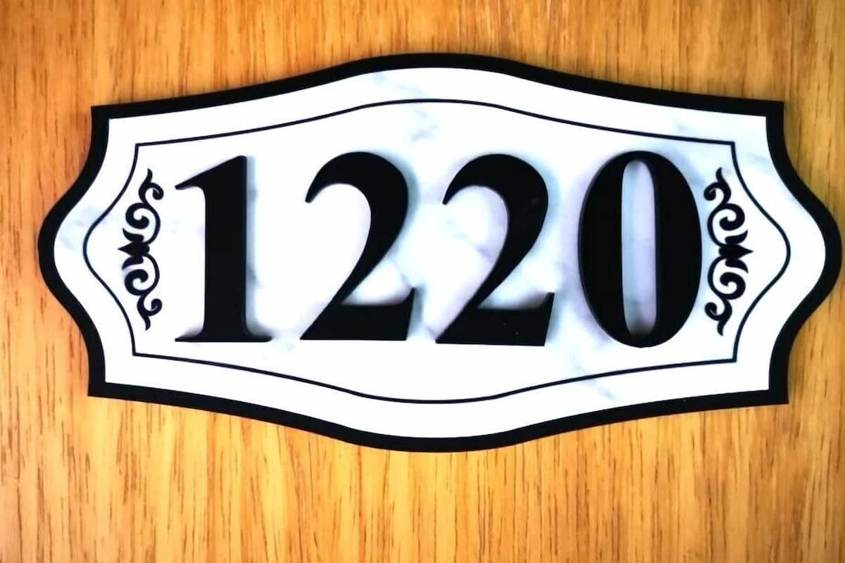 A house number sign with the number 1220.