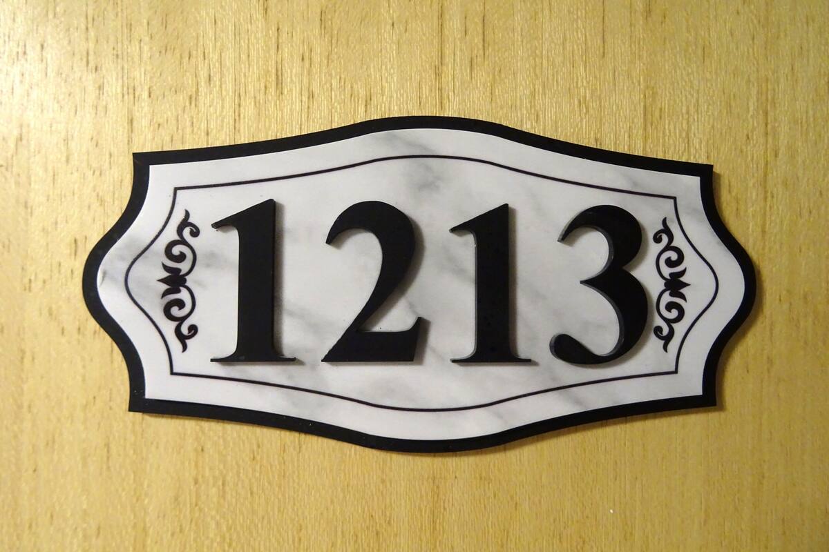 A house number sign with the number 1213.