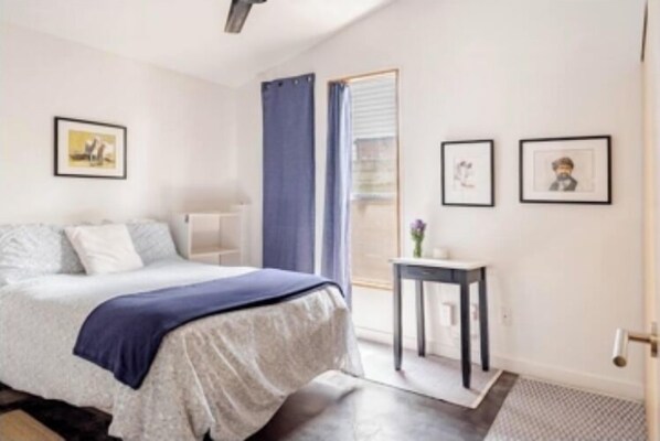 A modern bedroom with a bed, a small table, and framed pictures on the wall. - 3/2 Mod Hideaway, Laid-back Loft. ACL/ S Congress/ Downtown. Dog-Friendly (Austin)