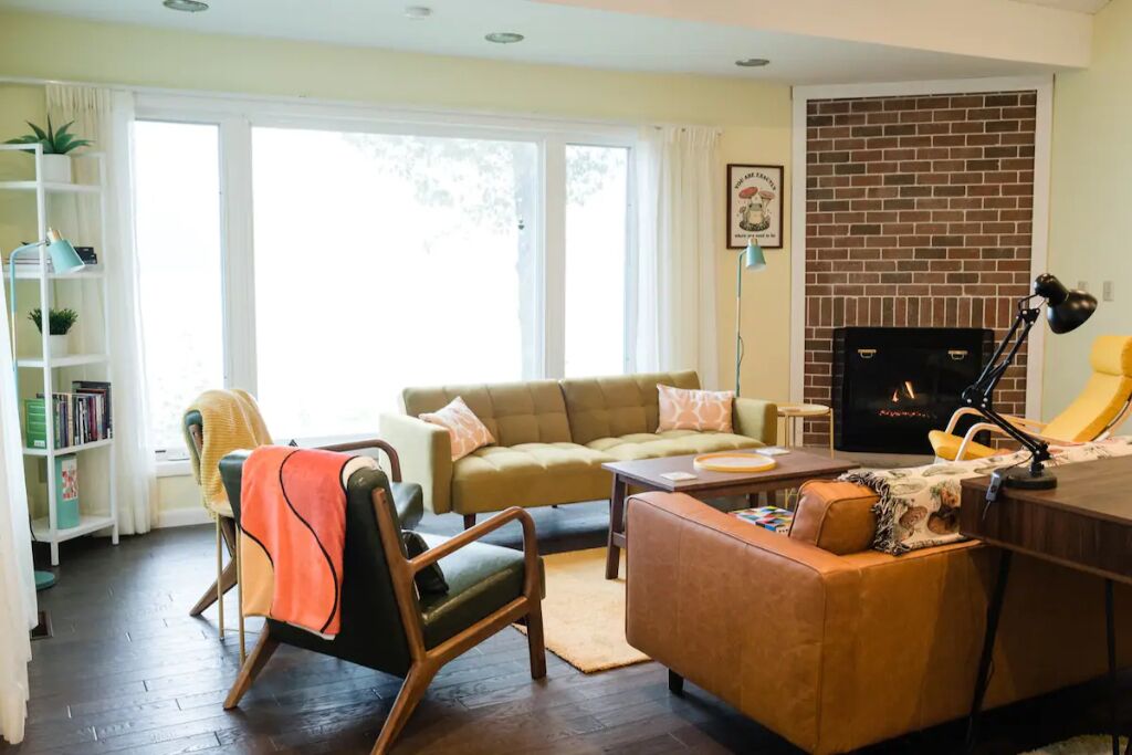 Living room with lake views, plenty of seating and a gas fireplace