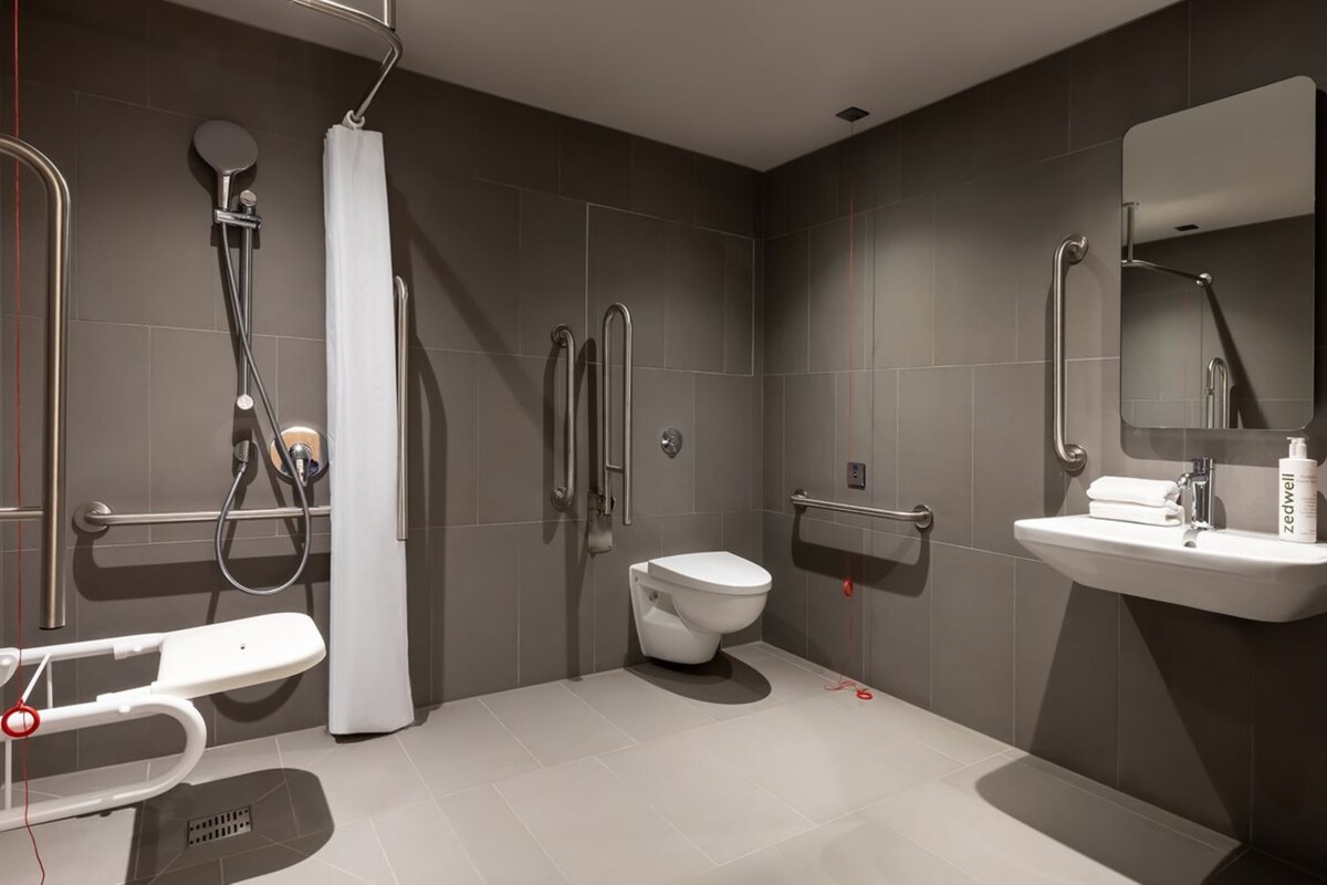 A modern bathroom with a toilet, bidet, and shower.