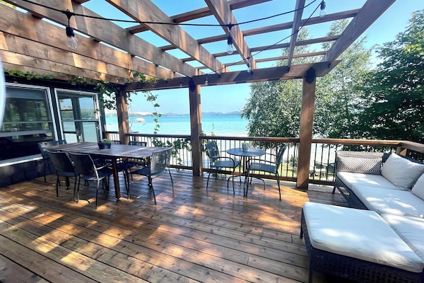 deck with a view. Dining table, bistro table and an l shaped sofa.