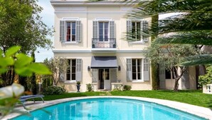 A two-story building with a swimming pool in front.