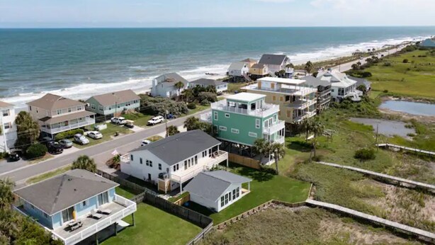 A coastal residential area with houses, a beach, and a road. - Luxury Sea Cabin Guest Suite - Across from Beach (Folly Beach)