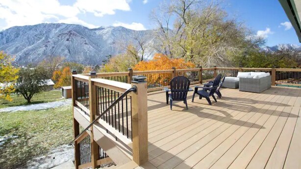A deck with outdoor seating and a view of mountains. - Kid and Dog Friendly Home w/ Amazing Views! (Glenwood Springs)