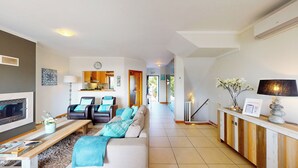A modern living room with a sofa, chairs, a TV, and a dining area with a table and chairs. - Vila Vida (8) | Private Heated Pool | Sea & Beach | Roof Terrace | Restaurants (Ferragudo)