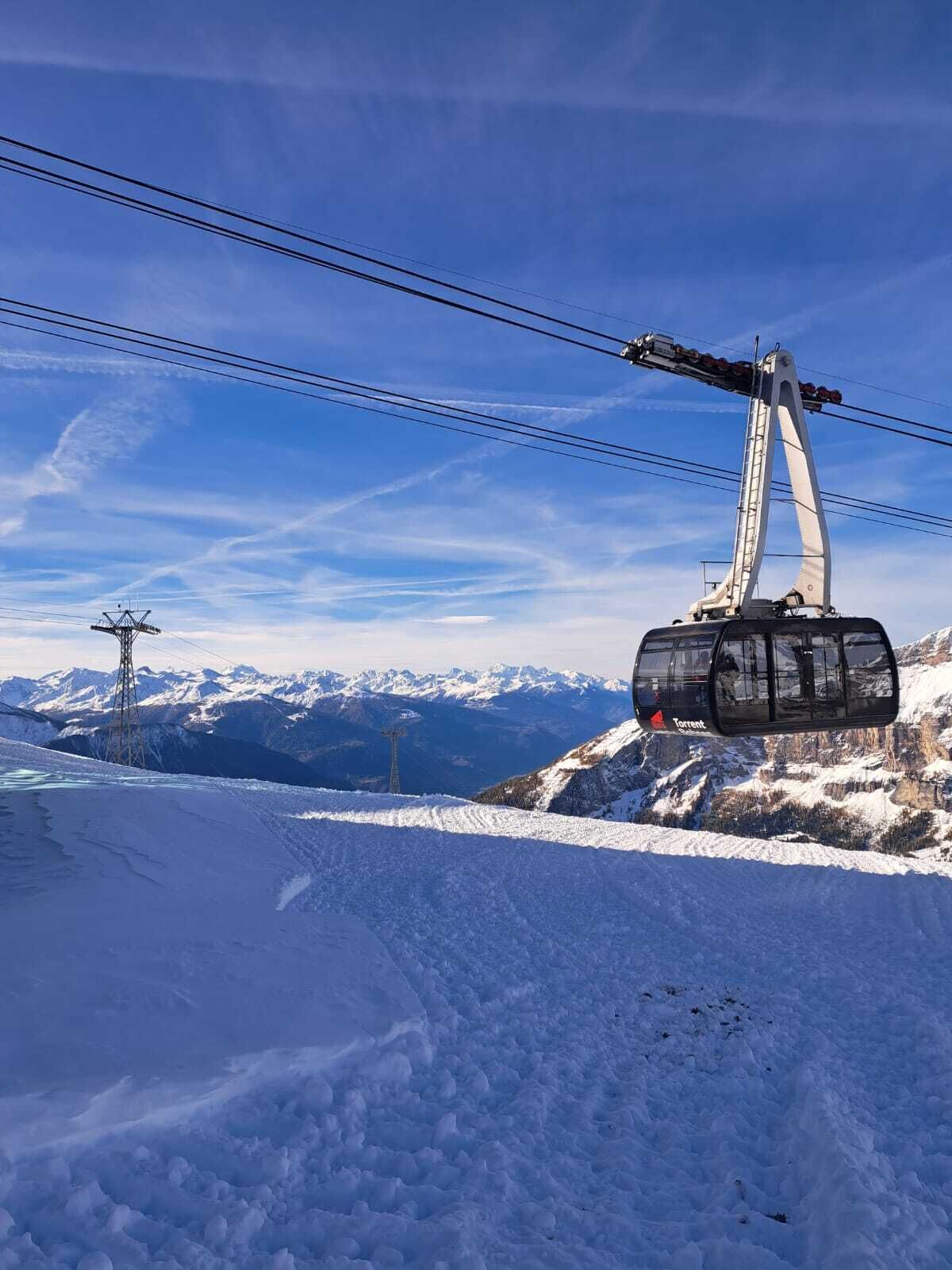 A cable car system with a mountainous backdrop.