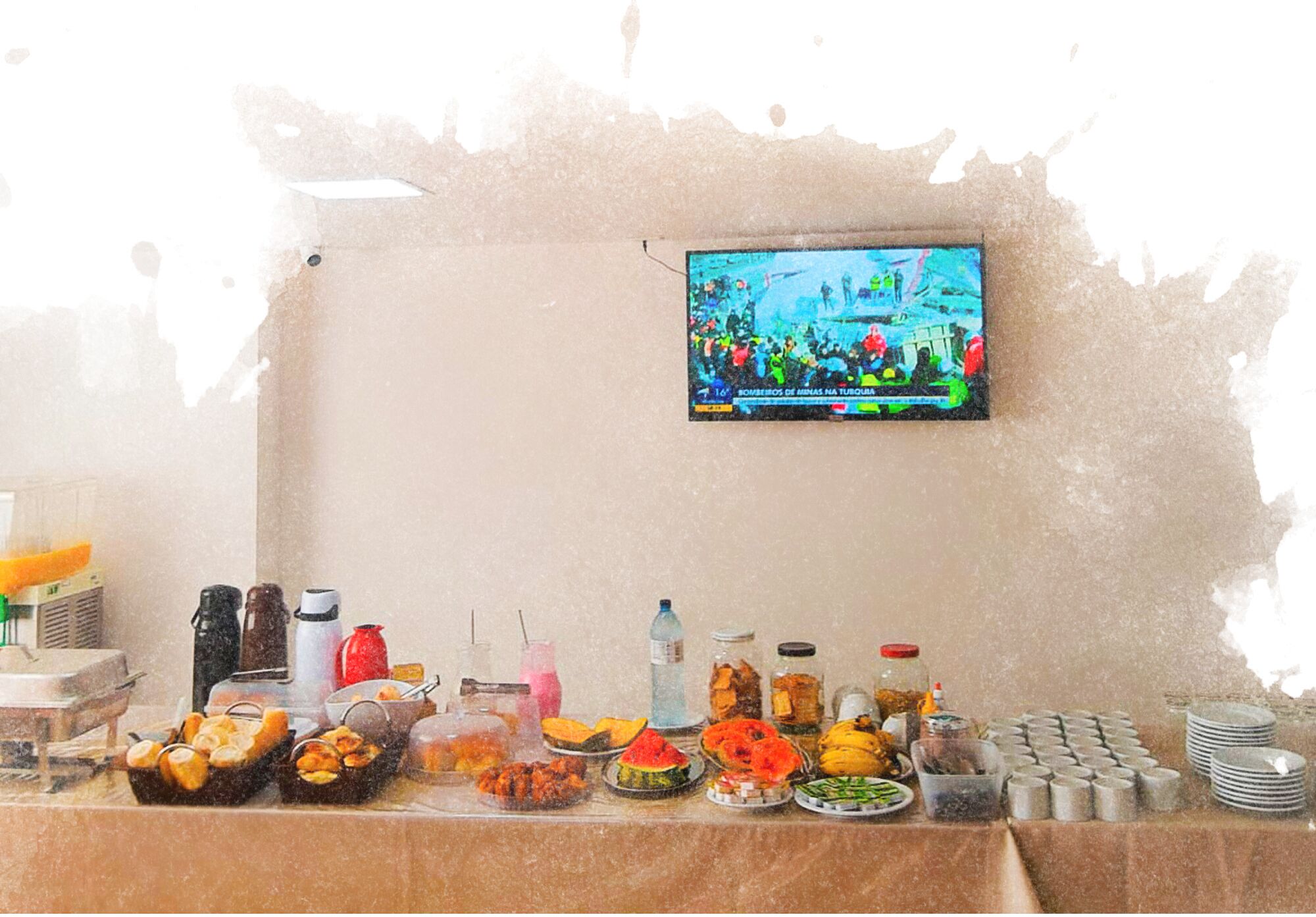 A buffet table with various food items and a television displaying a sports event.