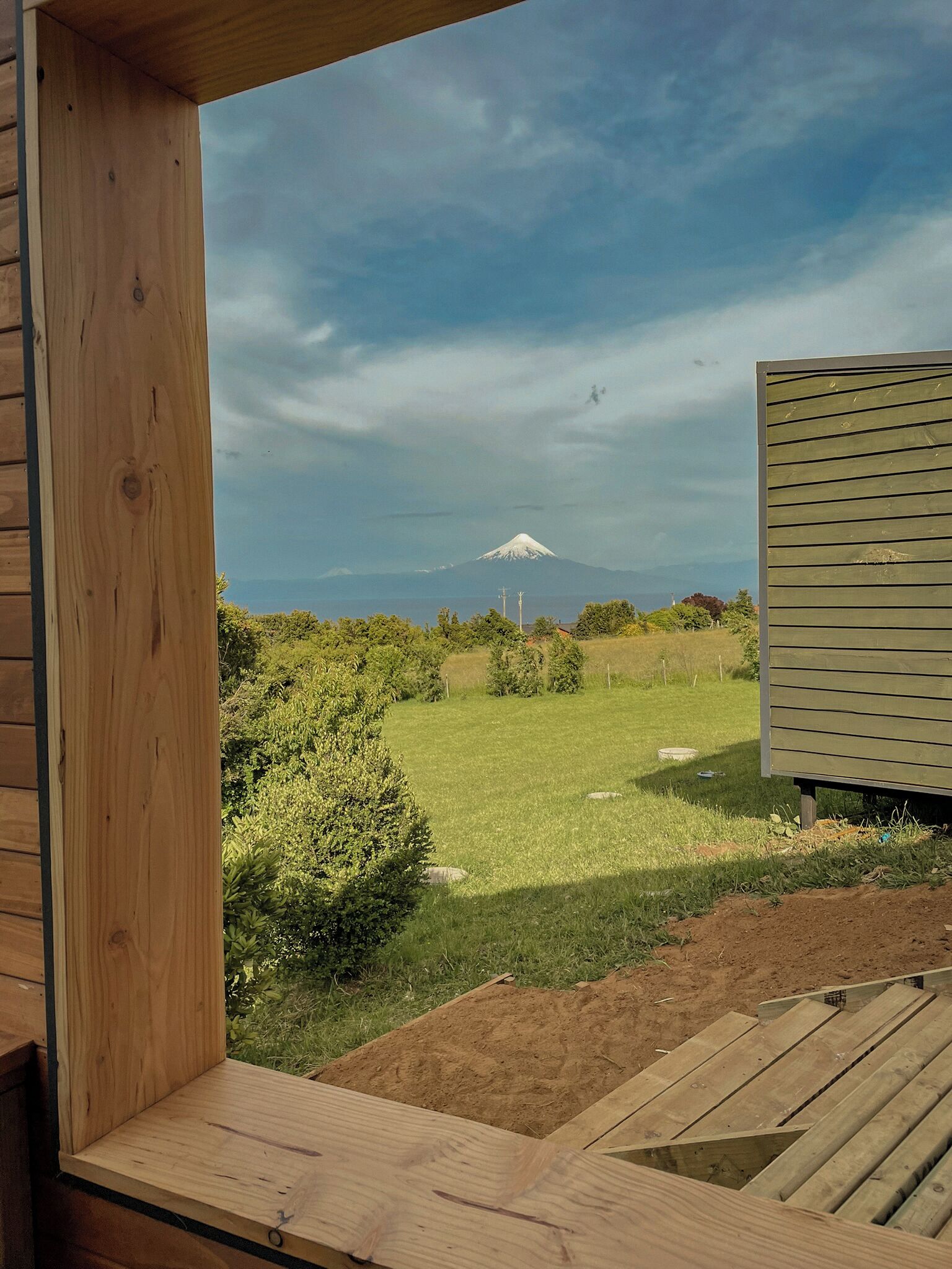 A wooden deck with a view of a mountain.