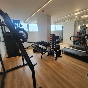 A gym with cardio equipment, weightlifting stations, and a treadmill. - Linhares Design Hotel (Linhares)