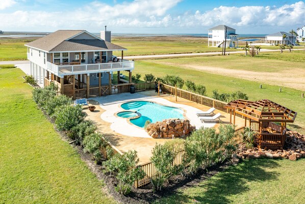 A large house with a pool, a deck, and a view of the ocean. - Dog-friendly house with private pool, spacious deck, central AC, & washer/dryer (Galveston)
