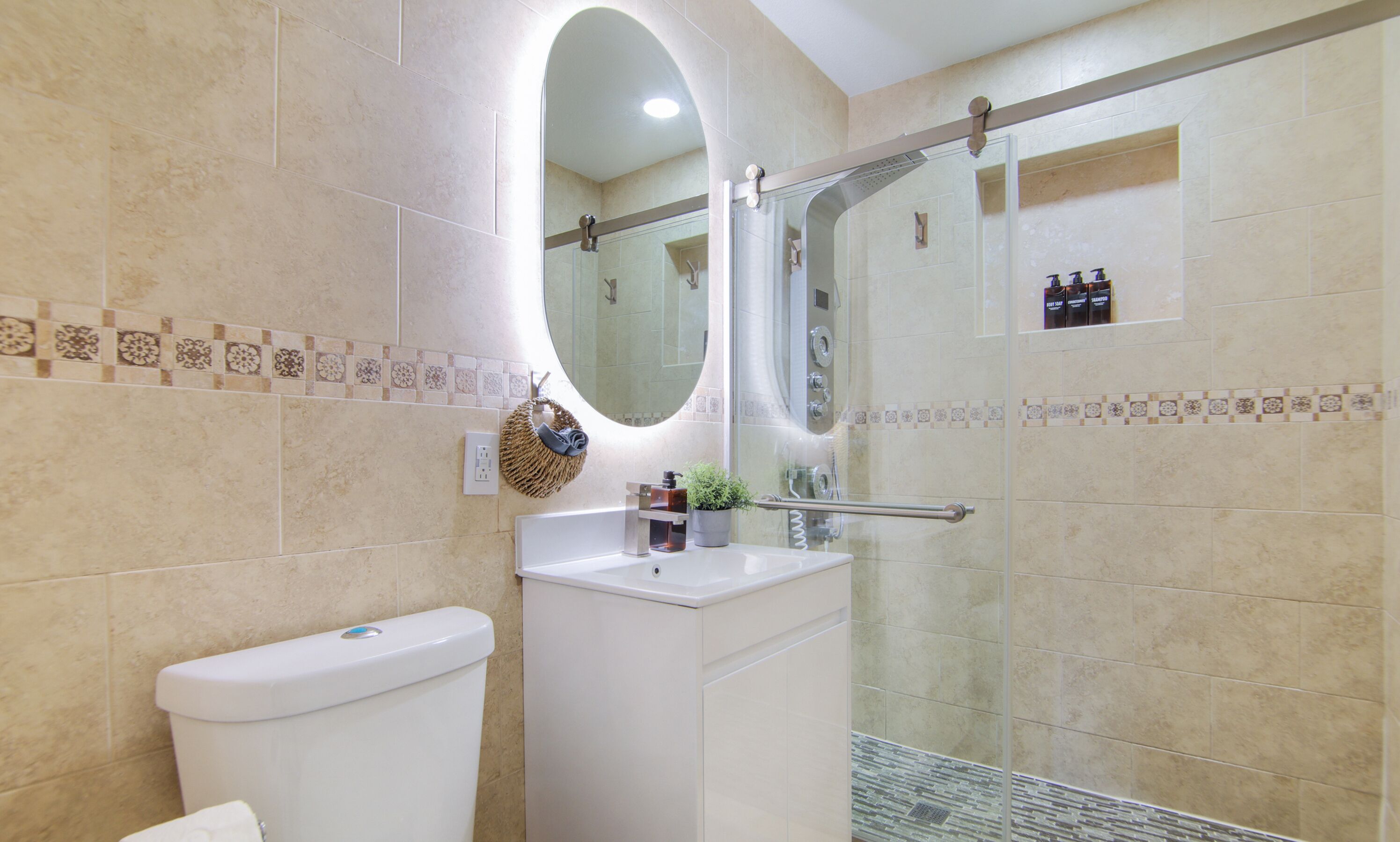 A bathroom with a toilet, sink, and shower area.