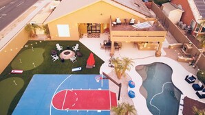 A residential property with a basketball court, a swimming pool, and a patio area with outdoor seating. - Phoenix Vacation Home -- Pool, Spa, Basketball & Putting Green (Phoenix)