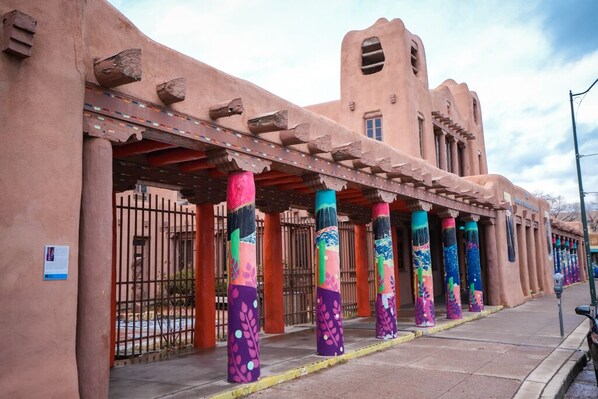A building with a distinctive architectural style, featuring a series of colorful pillars and a unique facade.