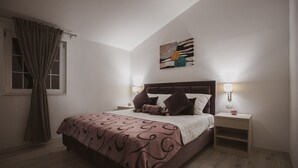 A bedroom with a bed, two bedside tables, a nightstand, a window with curtains, and a wall-mounted artwork. - A2 - Luxury apt w Terrace, Gym, Jacuzzi & Sauna (Dugi Rat)