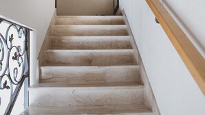 A staircase with a wooden handrail and a metal railing on one side. - A2 - Luxury apt w Terrace, Gym, Jacuzzi & Sauna (Dugi Rat)