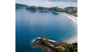 An aerial view of a coastal area with a beach, rocky outcrops, and lush greenery. -  Spectacular View Luxury Villa,  Overlooking Ocean at Bahia Pez Vela Resort (Guanacaste Province)