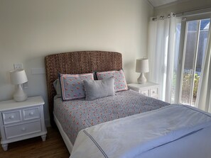 Cozy retreat with a large bed, bedside tables, and a view through the window.