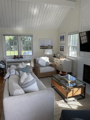 Cozy living space with a fireplace, sofa, and flat-screen TV.