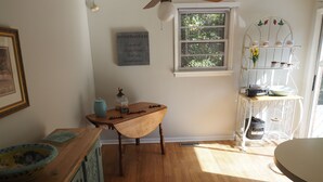 A room with a wooden table, a window with blinds, a shelf with kitchenware, and a wall-mounted sign. - Homemade in HICKORY! Salt Water Pool!  (Hickory)