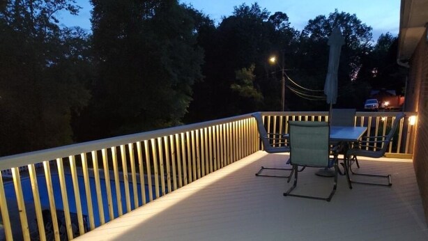 A wooden deck with a railing, a table, and chairs. - Homemade in HICKORY! Salt Water Pool!  (Hickory)