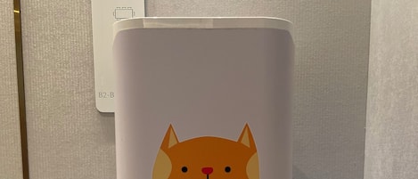 A white appliance with a cartoon cat and snake design, a control panel with a red button, and a label reading "B2-B".