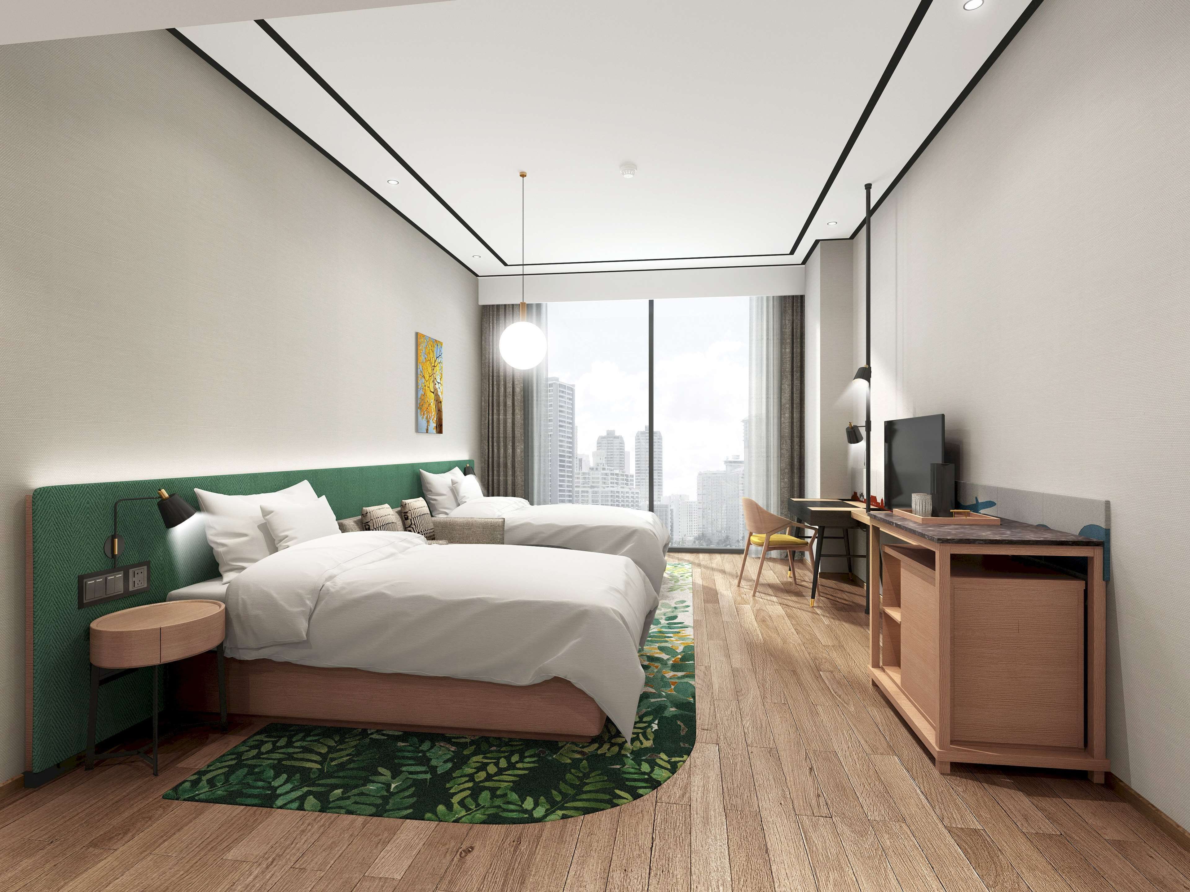 A modern hotel room with a large bed, a desk, and a view of the city.