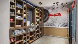 A snack display area with various packaged snacks and a 'TREATS' sign. - Hampton Inn Nicholasville Brannon Crossing (Nicholasville)