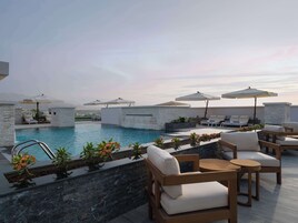 2 outdoor pools, open 8:00 AM to 7:00 PM, pool umbrellas, pool loungers